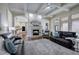 Inviting living room featuring fireplace, coffered ceiling, hardwood floors, and an open floor plan at 2160 Kensington Gates Nw Dr, Kennesaw, GA 30152