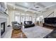 Spacious living room with coffered ceilings, a fireplace, a large rug, and large windows for natural light at 2160 Kensington Gates Nw Dr, Kennesaw, GA 30152