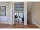 View through doorway to living room with hardwood floors, coffered ceiling, and abundant natural light at 2160 Kensington Gates Nw Dr, Kennesaw, GA 30152