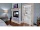 Well-appointed main bedroom with a fireplace and view to the ensuite bathroom at 2160 Kensington Gates Nw Dr, Kennesaw, GA 30152