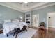 Stylish main bedroom with hardwood floors, a fireplace, and access to an ensuite bathroom at 2160 Kensington Gates Nw Dr, Kennesaw, GA 30152