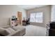 Bright office space with large window, desk, chair, bookshelf, and comfortable sitting area at 2160 Kensington Gates Nw Dr, Kennesaw, GA 30152