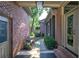 Covered side entrance featuring red brick, stone pathway, and an outdoor bench at 2160 Kensington Gates Nw Dr, Kennesaw, GA 30152