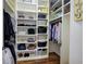 Walk-in closet with hardwood floors, custom shelving, and plenty of storage at 2160 Kensington Gates Nw Dr, Kennesaw, GA 30152