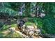 Backyard water feature with a small waterfall and lush greenery creates a serene environment at 2160 Kensington Gates Nw Dr, Kennesaw, GA 30152