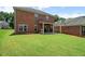 A spacious backyard with a well-maintained lawn and covered patio offers outdoor living at 1147 Scenic Park Trl, Lawrenceville, GA 30046