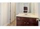 Bathroom with a white countertop, dark brown cabinets, and tile flooring, with a view into the kitchen at 1147 Scenic Park Trl, Lawrenceville, GA 30046