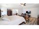 Spacious bedroom with a decorative bed frame, unique seating, and stylish flooring at 1147 Scenic Park Trl, Lawrenceville, GA 30046