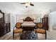 Grand bedroom with a decorative bed frame, unique seating, and stylish flooring at 1147 Scenic Park Trl, Lawrenceville, GA 30046