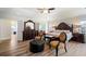 Grand bedroom with a decorative bed frame, unique seating, and stylish flooring at 1147 Scenic Park Trl, Lawrenceville, GA 30046