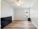 Bedroom with hardwood floors, neutral walls, with a ceiling fan and view out the window at 1147 Scenic Park Trl, Lawrenceville, GA 30046