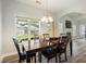 A bright dining room with a dark wood table and chairs, and a large window overlooking the backyard at 1147 Scenic Park Trl, Lawrenceville, GA 30046