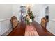Dining room showcases a wooden table, ornate chairs, and decorative centerpiece with bright interior at 1147 Scenic Park Trl, Lawrenceville, GA 30046