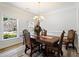 Elegant dining room with a wooden table set, chandelier, and bright windows at 1147 Scenic Park Trl, Lawrenceville, GA 30046