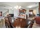 Dining room with dark wood table and view of the kitchen and staircase at 1147 Scenic Park Trl, Lawrenceville, GA 30046