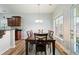 Dining room with a wood table and view of the kitchen area with wood cabinets and countertops at 1147 Scenic Park Trl, Lawrenceville, GA 30046