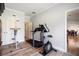 Exercise room with modern fitness equipment, hardwood floors and a view to the dining room at 1147 Scenic Park Trl, Lawrenceville, GA 30046