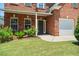 Front door with lush landscaping, beautiful brickwork, and garage at 1147 Scenic Park Trl, Lawrenceville, GA 30046