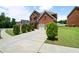 Inviting brick home featuring a driveway, lush lawn, and charming curb appeal at 1147 Scenic Park Trl, Lawrenceville, GA 30046