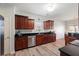A view of the kitchen with wood cabinets, stainless steel appliances, and a black countertop at 1147 Scenic Park Trl, Lawrenceville, GA 30046