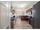 Modern kitchen featuring dark cabinets, stone countertops, and stainless steel appliances at 1147 Scenic Park Trl, Lawrenceville, GA 30046