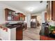 A wide view of the kitchen with stainless steel appliances, dark wood cabinets, and light floors at 1147 Scenic Park Trl, Lawrenceville, GA 30046