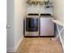 Laundry room with a full-size washer and dryer and wire shelving at 1147 Scenic Park Trl, Lawrenceville, GA 30046
