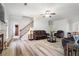 Spacious living room with wood-look floors, stairs, and leather furniture at 1147 Scenic Park Trl, Lawrenceville, GA 30046