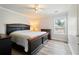 Main bedroom with hardwood floors, neutral walls, with a ceiling fan and view out the window at 1147 Scenic Park Trl, Lawrenceville, GA 30046