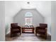 Comfortable seating area with two plush chairs and a view outside the arched window at 1147 Scenic Park Trl, Lawrenceville, GA 30046