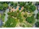 Overhead view of the park with green play structures, picnic pavilions, and landscaped walking trails and green spaces at 260 W Peachtree St, Norcross, GA 30071