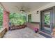Covered porch featuring stone flooring, brick pillars, and ceiling fan at 260 W Peachtree St, Norcross, GA 30071
