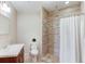 Bathroom with tiled walk-in shower, modern vanity, and neutral color scheme at 260 W Peachtree St, Norcross, GA 30071