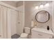 Bathroom featuring a marble vanity, round mirror, and walk-in shower at 260 W Peachtree St, Norcross, GA 30071