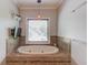 A luxurious tub set in tile with a TV, perfect for relaxation at 260 W Peachtree St, Norcross, GA 30071