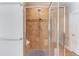 A shower featuring brown tilework and frameless glass at 260 W Peachtree St, Norcross, GA 30071