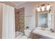 Bathroom featuring bathtub with shower, vanity, and neutral tile at 260 W Peachtree St, Norcross, GA 30071