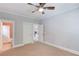 Carpeted bedroom shows door leading to bathroom at 260 W Peachtree St, Norcross, GA 30071