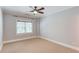 Neutral bedroom with carpet and large window at 260 W Peachtree St, Norcross, GA 30071