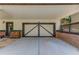 Carport featuring a concrete driveway, and gray doors at 260 W Peachtree St, Norcross, GA 30071