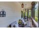 Covered porch with comfortable seating, string lights, and a ceiling fan for outdoor relaxation at 260 W Peachtree St, Norcross, GA 30071