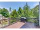 Outdoor deck area with brown railings, a grill, and views of trees at 260 W Peachtree St, Norcross, GA 30071