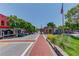 Downtown street scene with brick crosswalk and businesses on each side of the street at 260 W Peachtree St, Norcross, GA 30071