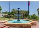 Decorative fountain in a park setting with American flags and steps at 260 W Peachtree St, Norcross, GA 30071