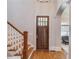 Welcoming foyer featuring hardwood floors, a staircase, and a decorative front door at 260 W Peachtree St, Norcross, GA 30071