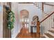 Elegant foyer with hardwood floors, staircase, and stylish decor creating a grand entrance at 260 W Peachtree St, Norcross, GA 30071