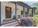 Inviting front porch with seating, decorative plants, and charming details like hanging lanterns at 260 W Peachtree St, Norcross, GA 30071