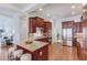 Modern kitchen with cherry cabinets, granite countertops, stainless steel appliances and seating at the island at 260 W Peachtree St, Norcross, GA 30071