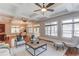 Open-concept living room with a fireplace, adjacent to a dining area and abundant natural light at 260 W Peachtree St, Norcross, GA 30071