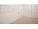 A carpeted basement area that has white walls, white trim and a wire shelving unit at 3209 Telhurst Way, Buford, GA 30519